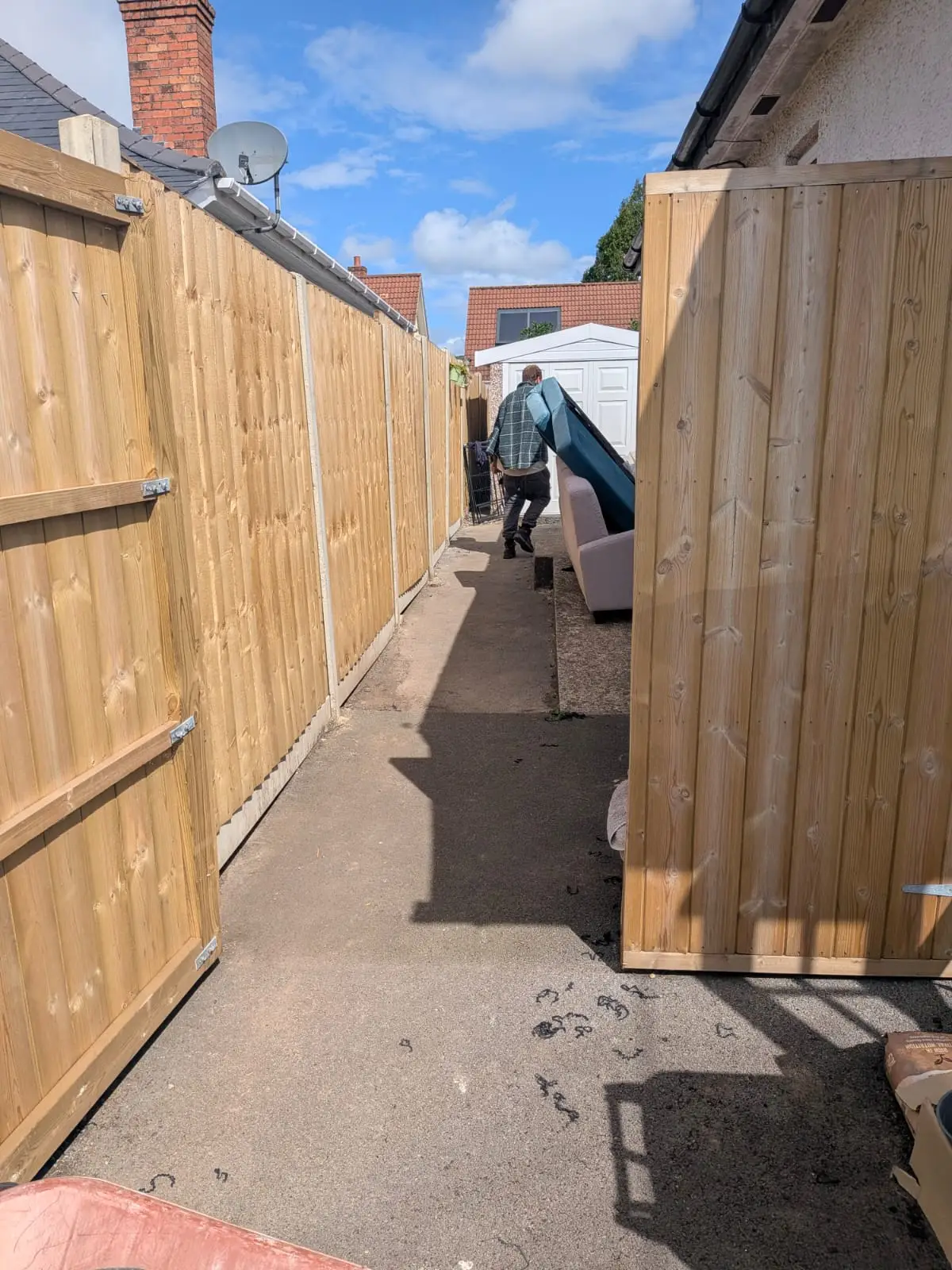 New close board fence panels, concrete posts and a matching gate fitted along a side passage