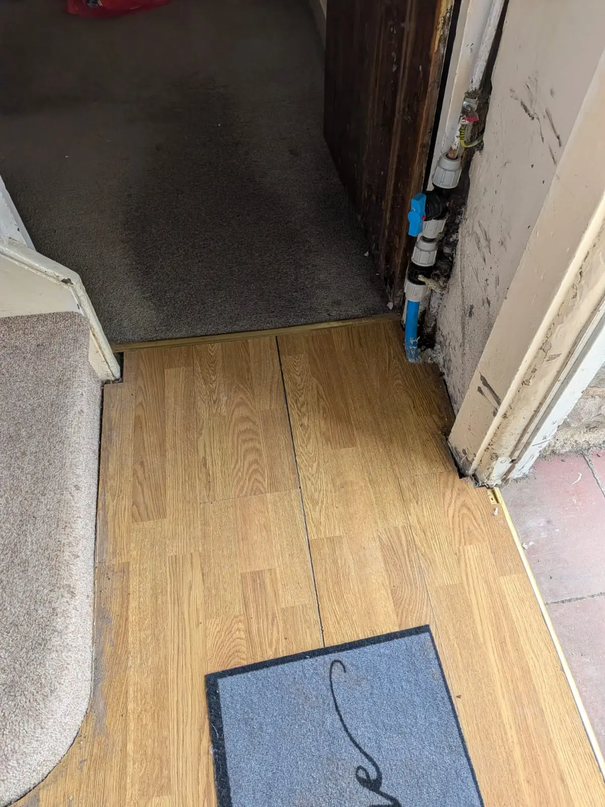 Hallway floor relaid up to the doorway after the incoming water main was replaced