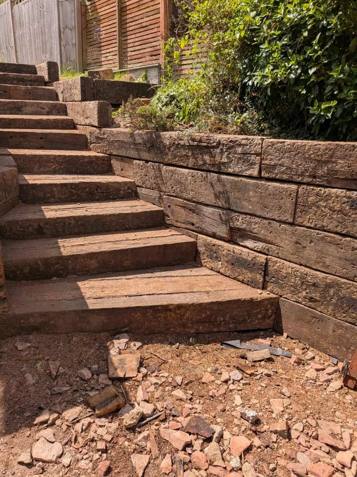 Railway sleeper retaining wall and matching sleeper steps built into a sloping garden